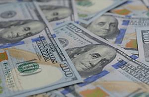 Stack of hundred-dollar bills representing reckless driving fines and surcharges in Georgia