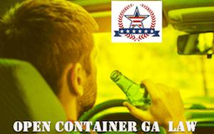 Man drinking from beer bottle while driving a car, a violation of Georgia open container law