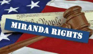 A gavel and American flag with the words "Miranda Rights" - Legal protections during before and during police interrogations