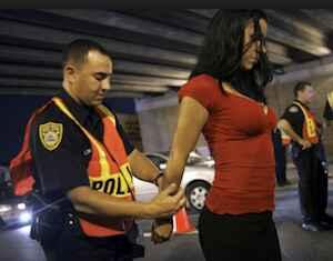 Police officer arresting a woman suspected of DUI Less Safe