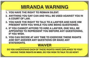 A yellow Miranda Rights card listing the official Miranda warnings given by police
